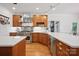 Kitchen featuring stainless steel appliances, wooden cabinets, and modern fixtures at 12900 Westmoreland Rd, Huntersville, NC 28078