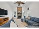 Bright living room with stone fireplace, ceiling fan, and a comfortable blue sectional sofa at 12900 Westmoreland Rd, Huntersville, NC 28078