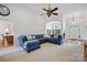 Spacious living room with a blue sectional couch and views into the dining room at 12900 Westmoreland Rd, Huntersville, NC 28078