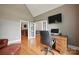 Dedicated office space with hardwood floors and a TV at 12900 Westmoreland Rd, Huntersville, NC 28078