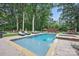 Beautiful pool featuring lounge seating, a hot tub, and lush green grass surrounded by mature shade trees at 12900 Westmoreland Rd, Huntersville, NC 28078