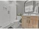 Modern bathroom featuring stylish tile, a glass-enclosed shower, and a sleek vanity at 13056 Long Common Pkwy, Huntersville, NC 28078