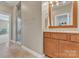 Bathroom boasts a double vanity with wood cabinets and a seamless glass shower at 13056 Long Common Pkwy, Huntersville, NC 28078