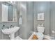 Half bath with a pedestal sink and framed mirror at 13056 Long Common Pkwy, Huntersville, NC 28078