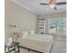 Bedroom with neutral paint, white trim, ceiling fan, and carpeted floors; large window overlooking trees at 13056 Long Common Pkwy, Huntersville, NC 28078