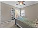 Bedroom with neutral paint, white trim, ceiling fan, and carpeted floors; desk with shelving at 13056 Long Common Pkwy, Huntersville, NC 28078