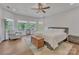 Bright bedroom with hardwood floors, natural light, and comfortable sitting area with windows at 13056 Long Common Pkwy, Huntersville, NC 28078