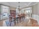 Well-lit dining room with hardwood floors, stylish area rug, and elegant chandelier at 13056 Long Common Pkwy, Huntersville, NC 28078