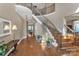 Grand foyer with hardwood floors, curved staircase with iron railings, and elegant decor at 13056 Long Common Pkwy, Huntersville, NC 28078