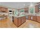 Spacious kitchen features a large island, stainless steel appliances, and hardwood floors at 13056 Long Common Pkwy, Huntersville, NC 28078