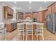 Kitchen island with seating, stainless steel appliances, and wood cabinets at 13056 Long Common Pkwy, Huntersville, NC 28078