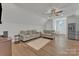 Cozy living room with modern finishes, seating, and stainless steel refrigerator at 13056 Long Common Pkwy, Huntersville, NC 28078