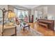 Sunlit living room with hardwood floors, large windows, and cozy seating for a warm and inviting atmosphere at 13056 Long Common Pkwy, Huntersville, NC 28078