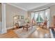 Bright living room with hardwood floors, bay window, stylish furniture, and a decorative rug at 13056 Long Common Pkwy, Huntersville, NC 28078