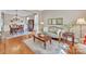 Cozy living room with elegant furnishings, hardwood floors, and an adjacent dining area at 13056 Long Common Pkwy, Huntersville, NC 28078