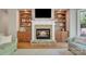 Living room fireplace with stone surround and built-in shelves at 13056 Long Common Pkwy, Huntersville, NC 28078