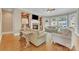 Cozy living room with a fireplace, built-in bookshelves, and large windows at 13056 Long Common Pkwy, Huntersville, NC 28078