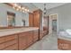 Main bathroom featuring neutral paint, tile floors, and a vanity with double sinks and lots of storage at 13056 Long Common Pkwy, Huntersville, NC 28078