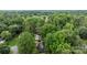 Scenic aerial perspective of a home situated among mature trees, highlighting its peaceful surroundings at 13446 Idlefield Ln, Matthews, NC 28105