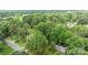 Lush greenery surrounds this home, providing a private, wooded setting near a quiet street at 13446 Idlefield Ln, Matthews, NC 28105