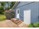Rear exterior featuring brick steps and a well-maintained white door leading to the home's entrance at 13446 Idlefield Ln, Matthews, NC 28105