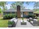 Cozy backyard with patio furniture, manicured lawn, and a view of the home at 13446 Idlefield Ln, Matthews, NC 28105