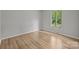 This bedroom features gleaming hardwood floors and a bright window to let the sun shine in at 13446 Idlefield Ln, Matthews, NC 28105