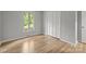 This bedroom features gleaming hardwood floors, bright window, and closet for storage at 13446 Idlefield Ln, Matthews, NC 28105
