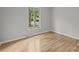 This bedroom features gleaming hardwood floors and a bright window to let the sun shine in at 13446 Idlefield Ln, Matthews, NC 28105