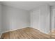 This bedroom features gleaming hardwood floors and a closet for storage at 13446 Idlefield Ln, Matthews, NC 28105