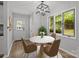 Cozy dining area with a marble table, four chairs, pendant lighting, and natural light at 13446 Idlefield Ln, Matthews, NC 28105