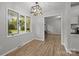 Bright dining area with hardwood floors, natural light, and contemporary pendant lighting at 13446 Idlefield Ln, Matthews, NC 28105