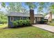 Charming home exterior with lush landscaping and a brick chimney on a sunny day at 13446 Idlefield Ln, Matthews, NC 28105