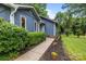 Well-manicured front exterior with blue siding, a welcoming pathway, and colorful flower accents at 13446 Idlefield Ln, Matthews, NC 28105