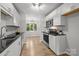 Bright kitchen featuring modern appliances, white cabinetry, and hardwood floors at 13446 Idlefield Ln, Matthews, NC 28105