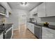 Well-lit kitchen with stainless steel appliances, sleek countertops, and light wood floors at 13446 Idlefield Ln, Matthews, NC 28105