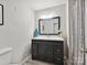 Stylish bathroom with a dark vanity, large mirror, and modern lighting at 136 Gable Rd, Mooresville, NC 28115