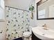 Bright bathroom featuring patterned shower curtain, modern sink, and tiled floors at 136 Gable Rd, Mooresville, NC 28115