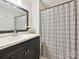 Well-lit bathroom with a dark vanity, white countertop, and striped shower curtain at 136 Gable Rd, Mooresville, NC 28115