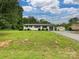 Well-manicured lawn with a charming white brick home, attached garage, and ample space at 136 Gable Rd, Mooresville, NC 28115