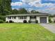 Charming one-story home with a well-maintained lawn, painted white brick and an attached garage at 136 Gable Rd, Mooresville, NC 28115