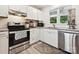 White tiled kitchen featuring stainless steel appliances, granite countertops, and a window at 136 Gable Rd, Mooresville, NC 28115
