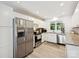 Well-lit kitchen featuring stainless steel appliances and white cabinetry and wood flooring at 136 Gable Rd, Mooresville, NC 28115