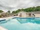 Relaxing pool area featuring a spacious deck, lounge seating, and mature trees at 136 Gable Rd, Mooresville, NC 28115