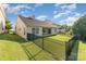 Spacious backyard with a covered patio and well-maintained lawn, surrounded by a black metal fence at 13830 Riding Hill Ave, Charlotte, NC 28213