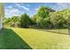 Fenced backyard offering ample green space, privacy, and shade from mature trees at 13830 Riding Hill Ave, Charlotte, NC 28213