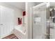Bright bathroom featuring a soaking tub, shower, and neutral color palette at 13830 Riding Hill Ave, Charlotte, NC 28213