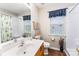 Clean bathroom featuring a modern vanity, toilet, and shower-tub combination at 13830 Riding Hill Ave, Charlotte, NC 28213