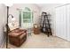 Cozy bedroom with a recliner chair, and a decorative shelf near the window at 13830 Riding Hill Ave, Charlotte, NC 28213