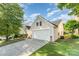 View of the side of the house with a driveway leading to an attached garage with green grass at 13830 Riding Hill Ave, Charlotte, NC 28213
